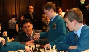 Leader of the Green Party, Eamon Ryan, receives instruction from Gaelscoil Cholmcille children at Comórtas Fichille Cúige Laighean in the Mansion House